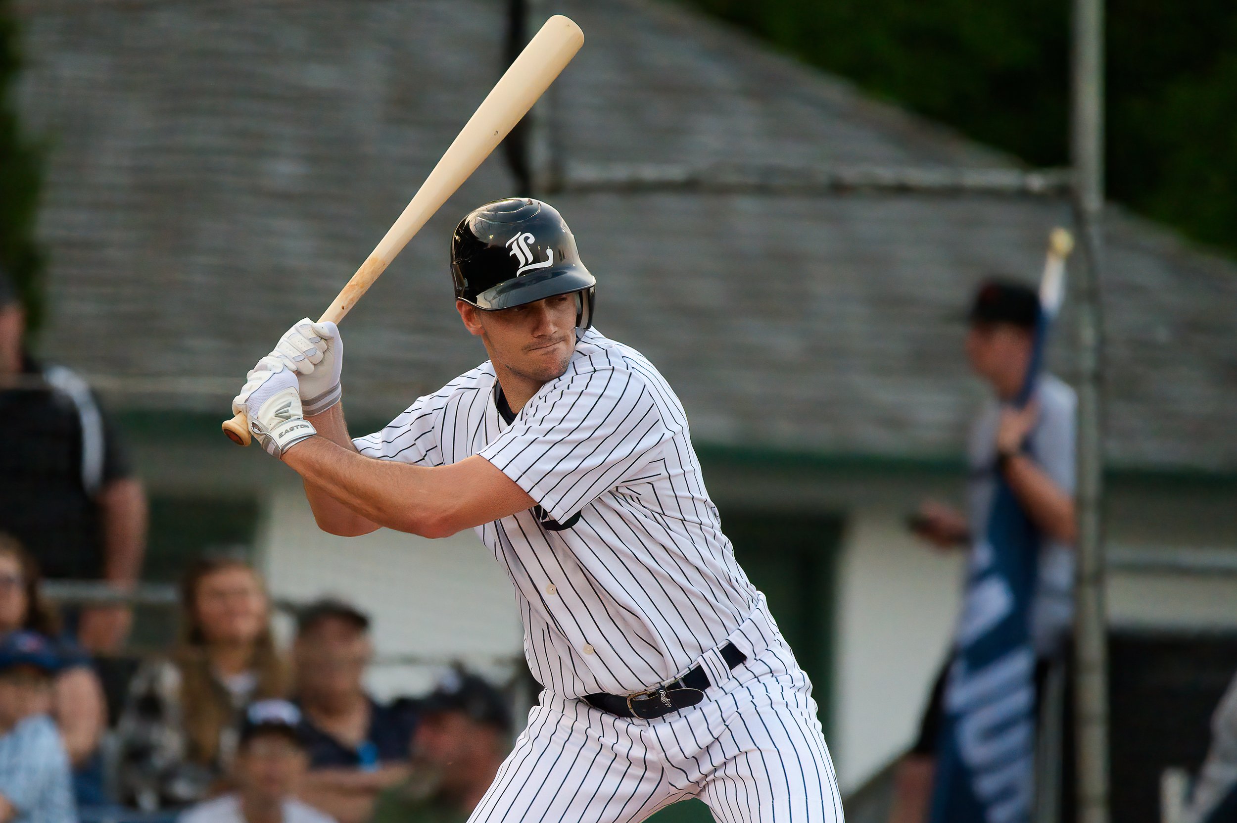 Baseball player holding a bat ready to swing.