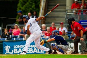 Baseball player mid swing