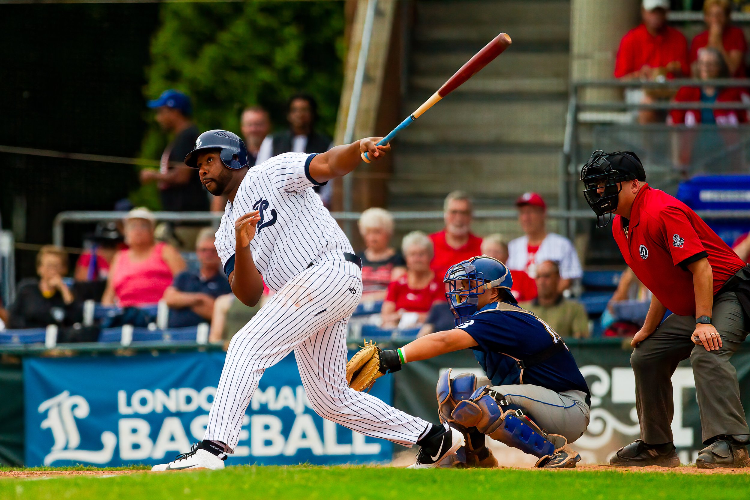 Baseball player mid swing