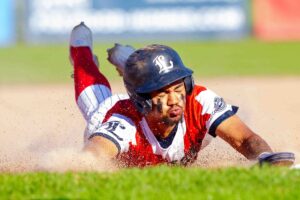 A baseball player sliding into the base.