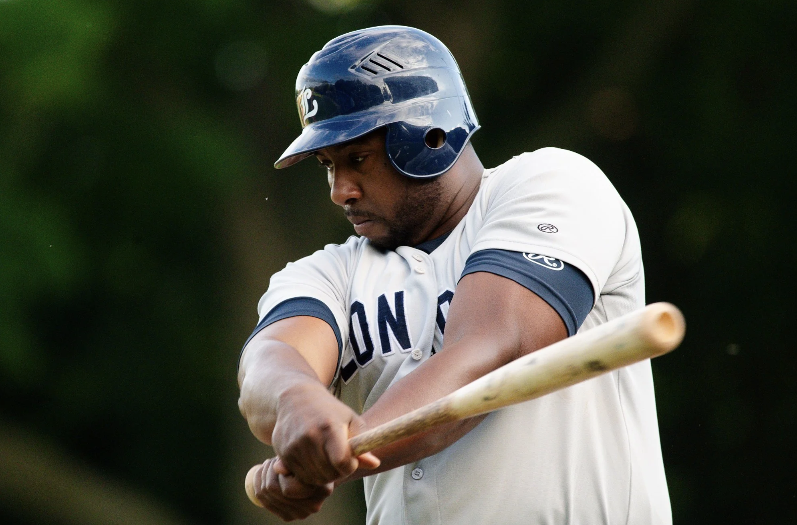 Baseball player swinging a bat.