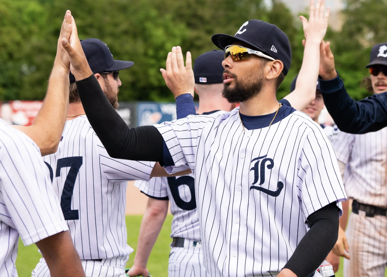 Baseball players high-five each other
