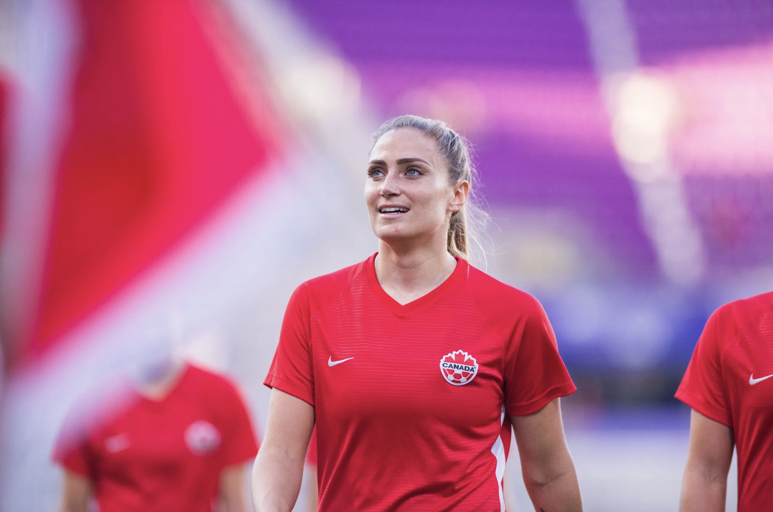 Woman in a red Canada soccer jersey