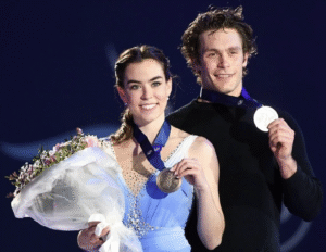 Two figure skaters holding their medals