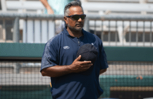 A man standing on a baseball field with his hat over his heart