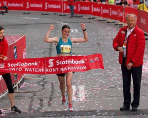 Woman running across the finish line